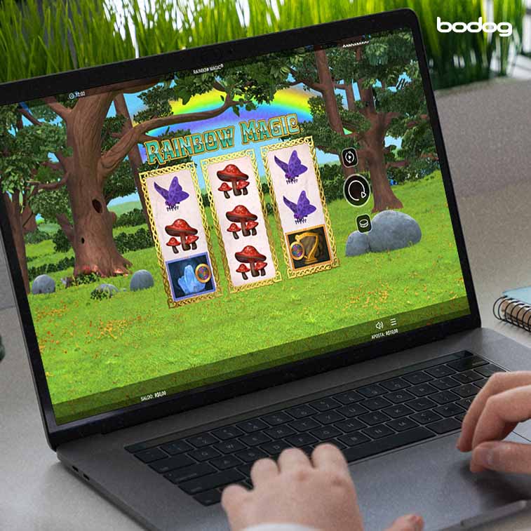 pessoa jogando o slot Rainbow Magic em um computador